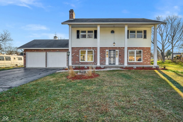 view of front of property with a garage and a front lawn