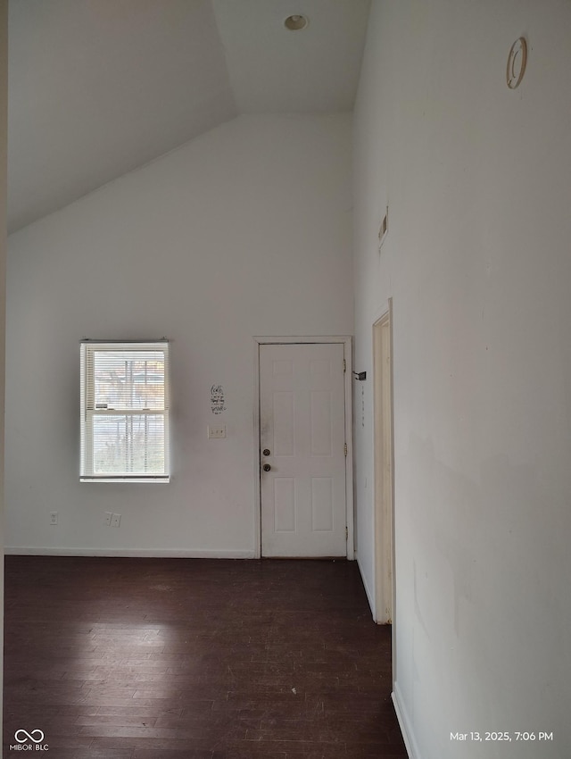 entrance foyer featuring dark wood finished floors, high vaulted ceiling, and baseboards