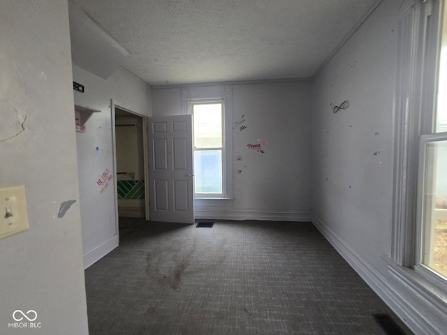 spare room with a textured ceiling