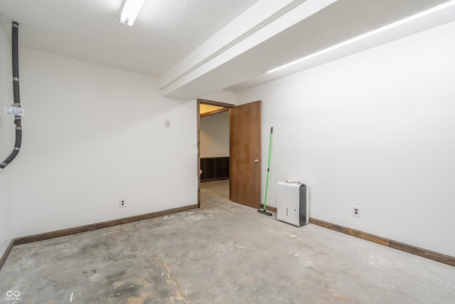 unfurnished room with concrete flooring