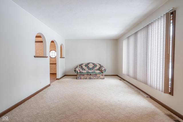 unfurnished room featuring light colored carpet