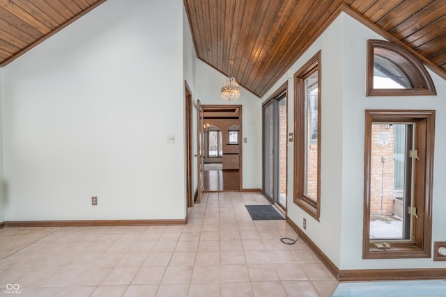 tiled entryway featuring wood ceiling, high vaulted ceiling, and an inviting chandelier