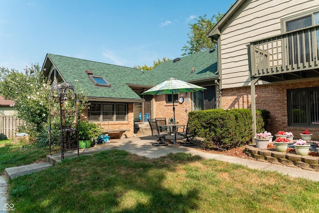 back of house with a yard and a patio area