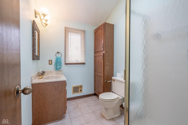 bathroom featuring tile patterned floors, vanity, toilet, and a shower with shower door