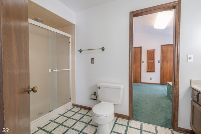 bathroom featuring vaulted ceiling, vanity, toilet, and a shower with door