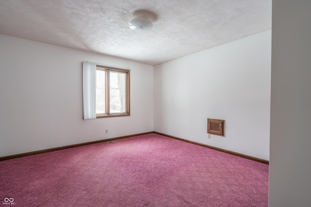 spare room with carpet floors and a textured ceiling