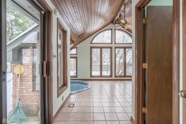 entrance foyer with vaulted ceiling, light tile patterned floors, ceiling fan, and wood ceiling