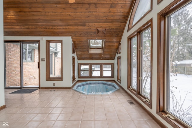 interior space with vaulted ceiling with skylight and wooden ceiling