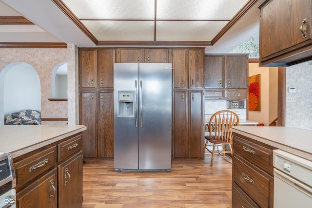 kitchen featuring crown molding, dishwasher, stainless steel fridge with ice dispenser, and light wood-type flooring