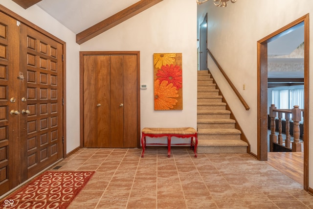 entrance foyer with vaulted ceiling with beams