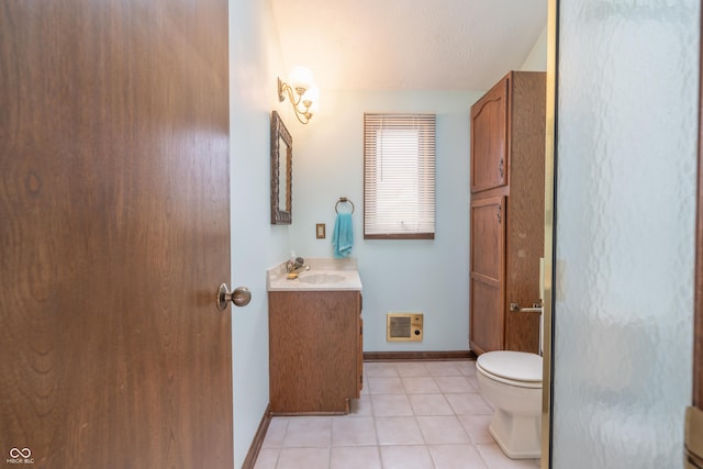 bathroom with vanity, heating unit, tile patterned floors, and toilet