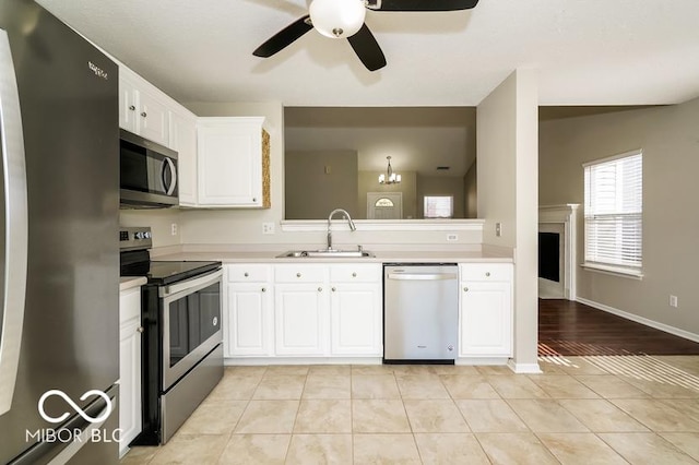 kitchen with white cabinetry, sink, stainless steel appliances, and light tile patterned flooring