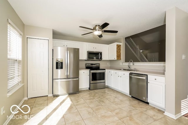 kitchen featuring white cabinetry, ceiling fan, stainless steel appliances, and sink