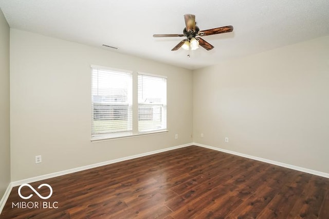 unfurnished room featuring dark hardwood / wood-style floors and ceiling fan