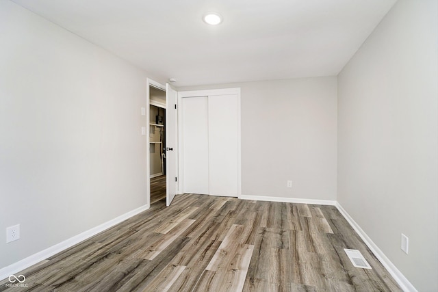 unfurnished room with hardwood / wood-style flooring