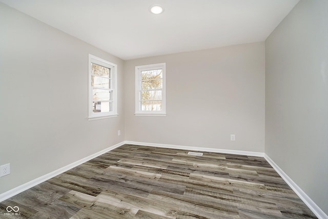 spare room with hardwood / wood-style flooring