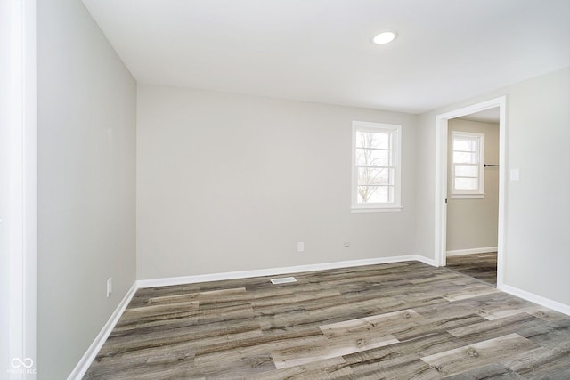 spare room with hardwood / wood-style flooring