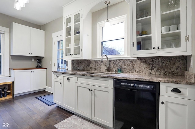 kitchen with black dishwasher, dark wood-style flooring, backsplash, white cabinetry, and a sink