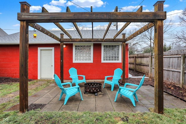 view of patio featuring an outdoor fire pit, fence, and a pergola