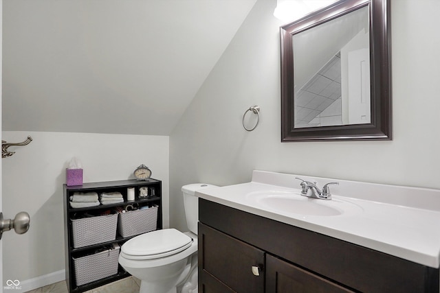 half bathroom featuring lofted ceiling, toilet, and vanity