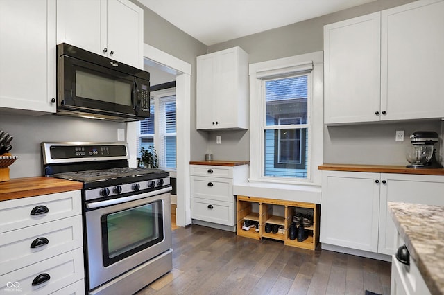 kitchen featuring wooden counters, dark wood-type flooring, stainless steel gas stove, white cabinetry, and black microwave