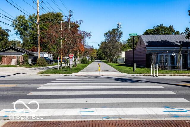 view of street featuring sidewalks, traffic signs, and curbs