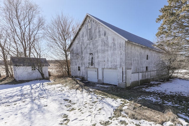 exterior space with a garage and an outbuilding