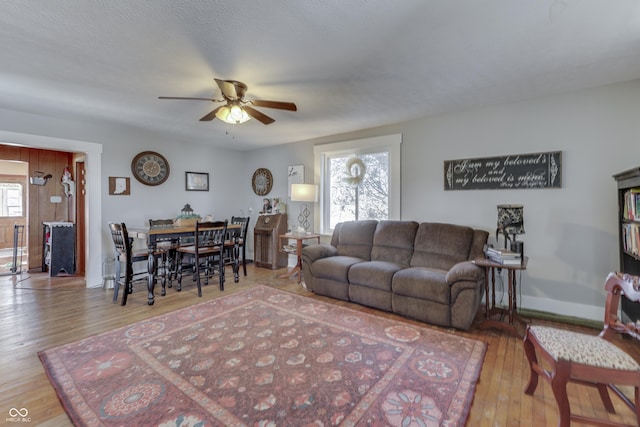 living room with ceiling fan, light hardwood / wood-style floors, and a wealth of natural light