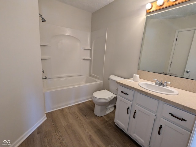 full bathroom featuring wood-type flooring, toilet,  shower combination, and vanity