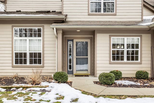 view of snow covered property entrance