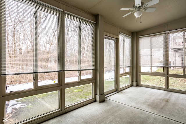 unfurnished sunroom with ceiling fan