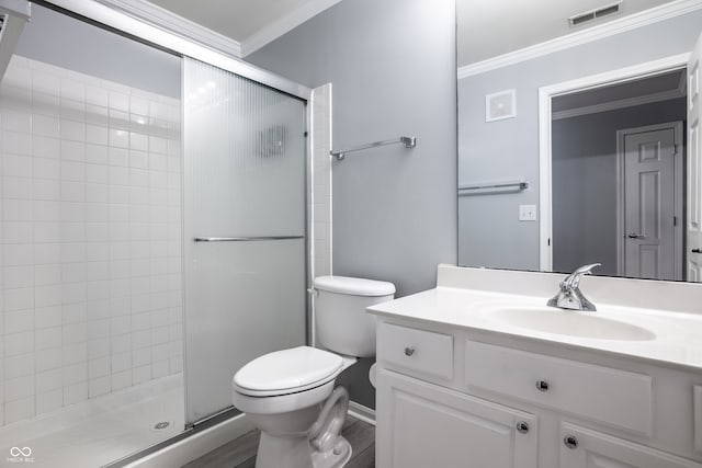 bathroom with ornamental molding, vanity, an enclosed shower, and toilet