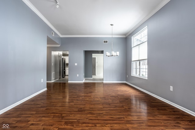 spare room with ornamental molding, dark wood-type flooring, and a notable chandelier