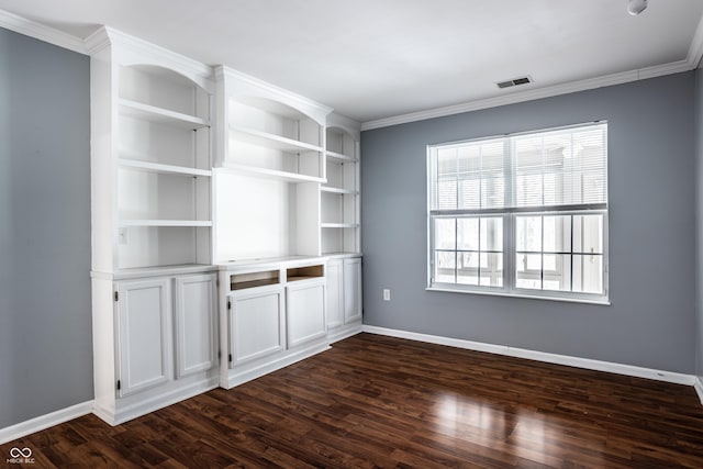 spare room with ornamental molding and dark hardwood / wood-style floors