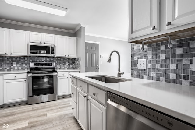 kitchen featuring white cabinetry, appliances with stainless steel finishes, and sink