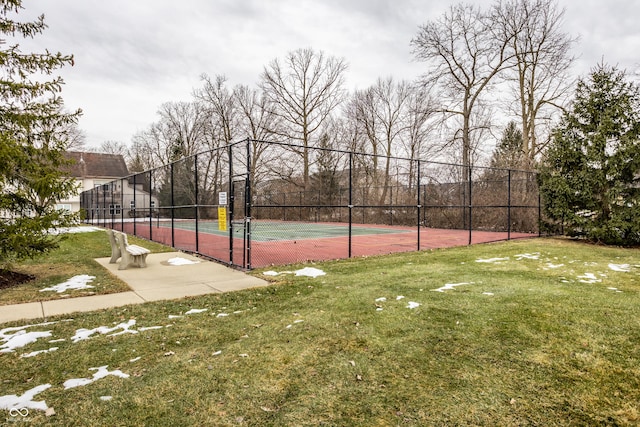 view of sport court with a lawn