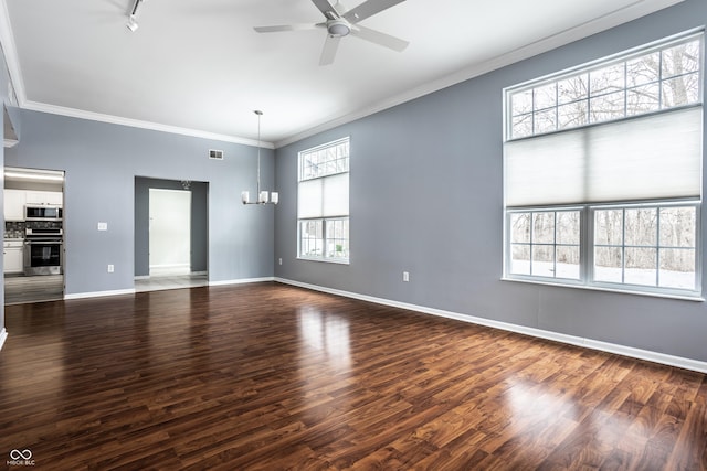 interior space featuring ceiling fan with notable chandelier, ornamental molding, and dark hardwood / wood-style floors