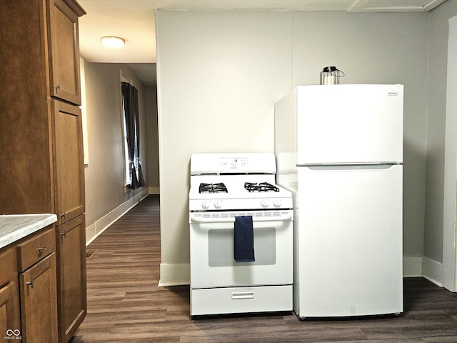 kitchen featuring white appliances and dark wood-type flooring