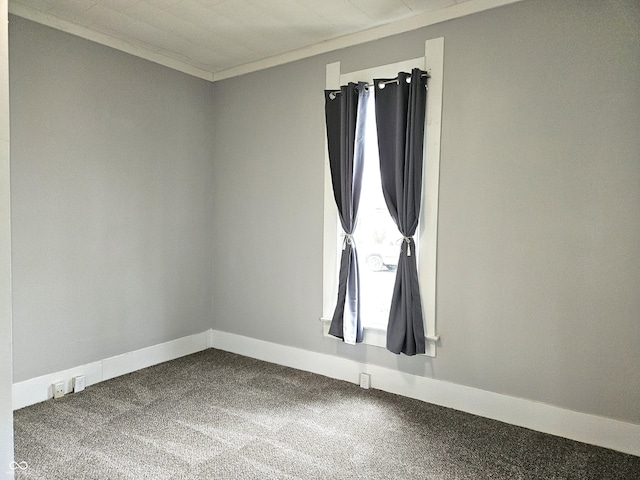 carpeted empty room featuring ornamental molding