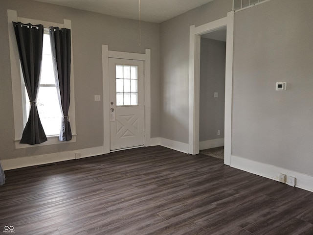 entryway with dark hardwood / wood-style flooring