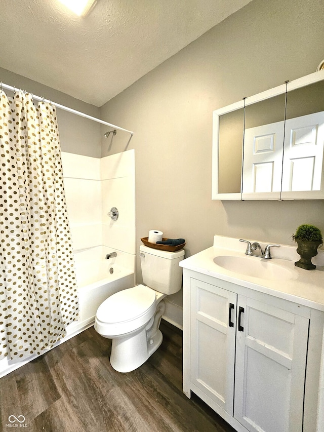 full bathroom featuring toilet, wood-type flooring, a textured ceiling, vanity, and shower / bath combo with shower curtain