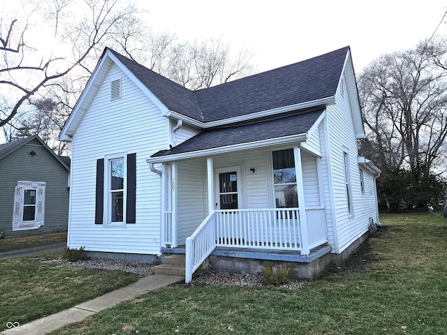 bungalow-style house with a porch and a front yard