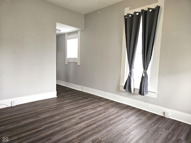 unfurnished room featuring dark hardwood / wood-style floors