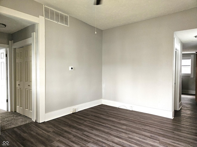 empty room with dark hardwood / wood-style floors