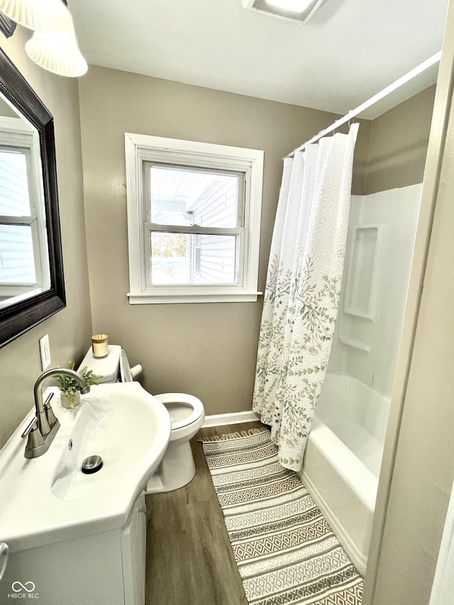 full bathroom featuring vanity, toilet, hardwood / wood-style floors, and shower / bath combo