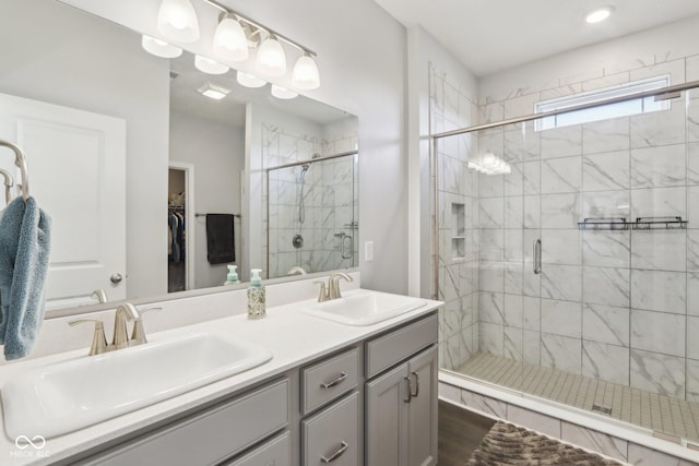 bathroom featuring vanity, wood-type flooring, and walk in shower