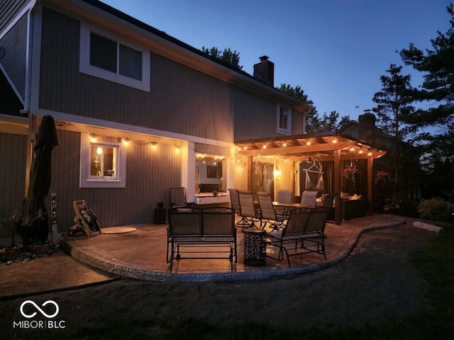 956 Dorchester Dr, Noblesville, IN 46062 - back of property featuring a chimney, a patio, a pergola, and outdoor dining space