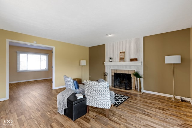 956 Dorchester Dr, Noblesville, IN 46062 - living area featuring wood finished floors, a tile fireplace, and baseboards