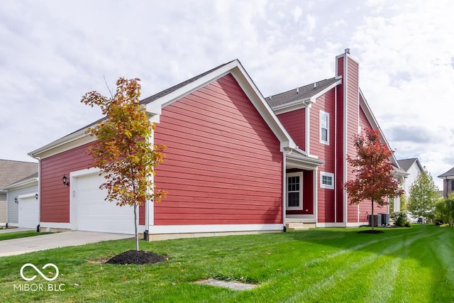 view of front facade with a garage, central air condition unit, and a front lawn