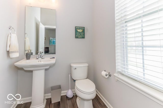 bathroom with sink, hardwood / wood-style flooring, and toilet